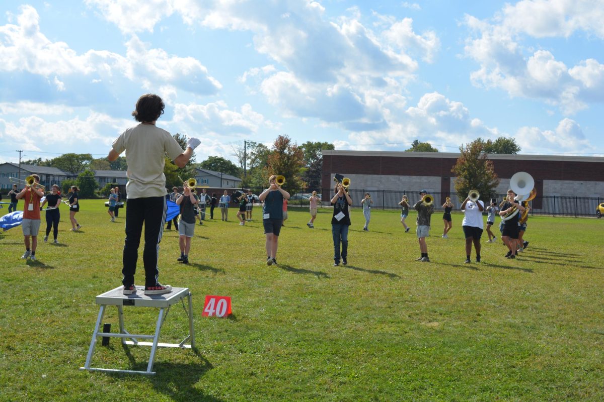 Under the direction of junior drum major Avery Water, the band practices after in preparation for a football game.